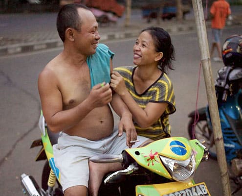A common definition of the middle class involves simultaneous ownership of a television, refrigerator, and motorcycle or car. This couple is from Ternate, North Maluku. Photo by S. Chris Brown.