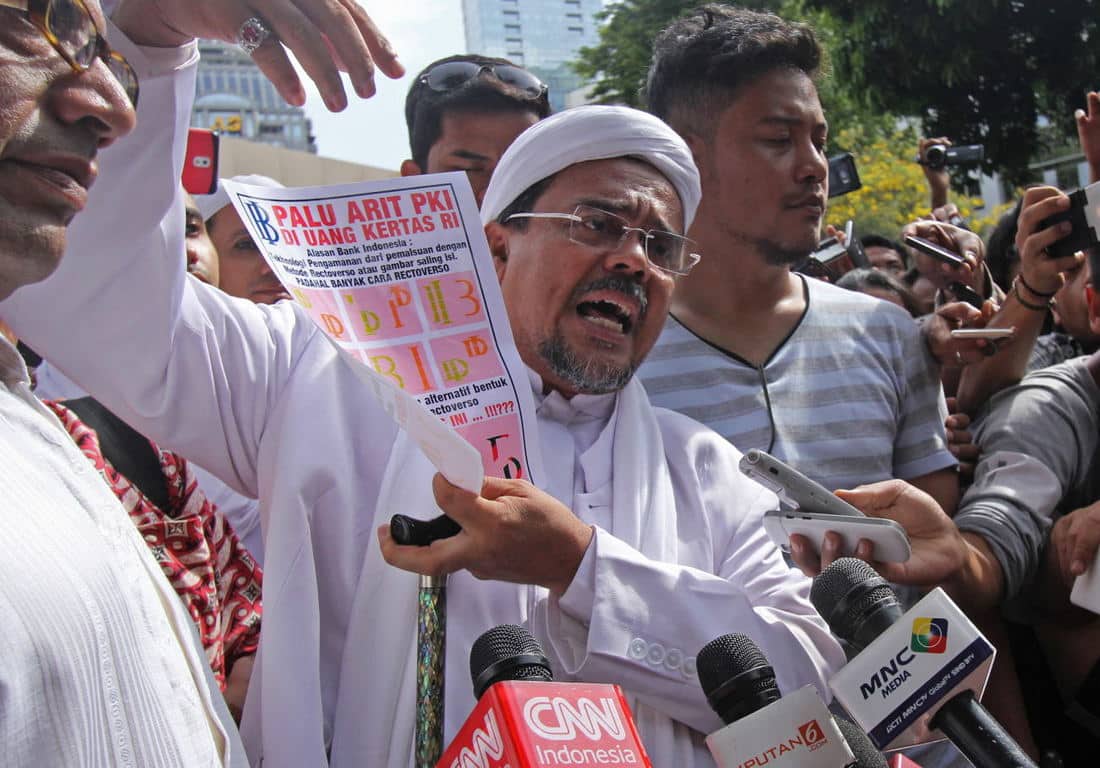 Islamic Defenders Front (FPI) leader Rizieq Shihab was reported for defamation after claiming Bank Indonesia produced banknotes with communist symbols. Photo by Reno Esnir for Antara.